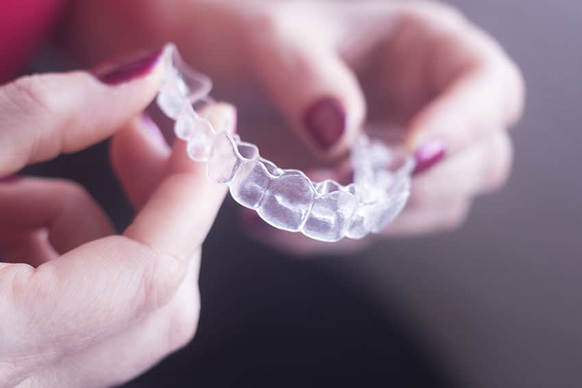 display of Invisalign clear braces being held